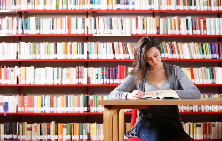 Portrait of a student girl studying at library