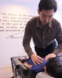 Image of chiropractor adjusting child.