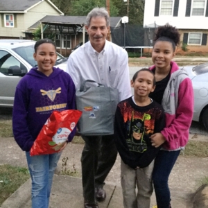 Sherman faculty member with a family receiving gift.
