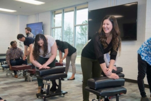 chiropractic students practicing in the classroom