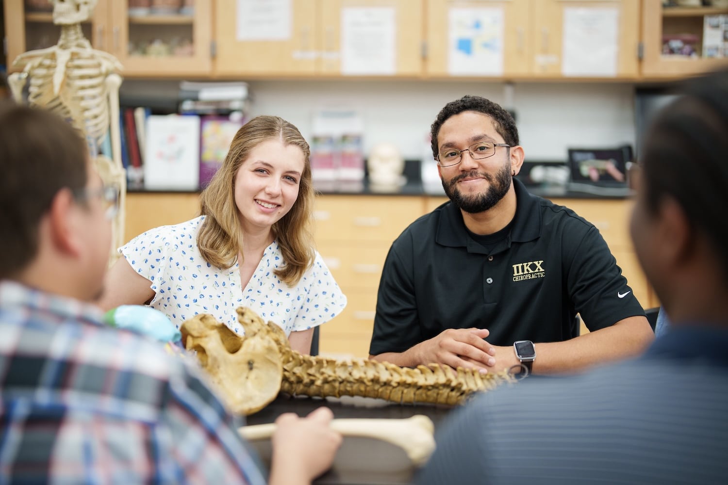 Students Looking at the camera while in a chiropractic classroom