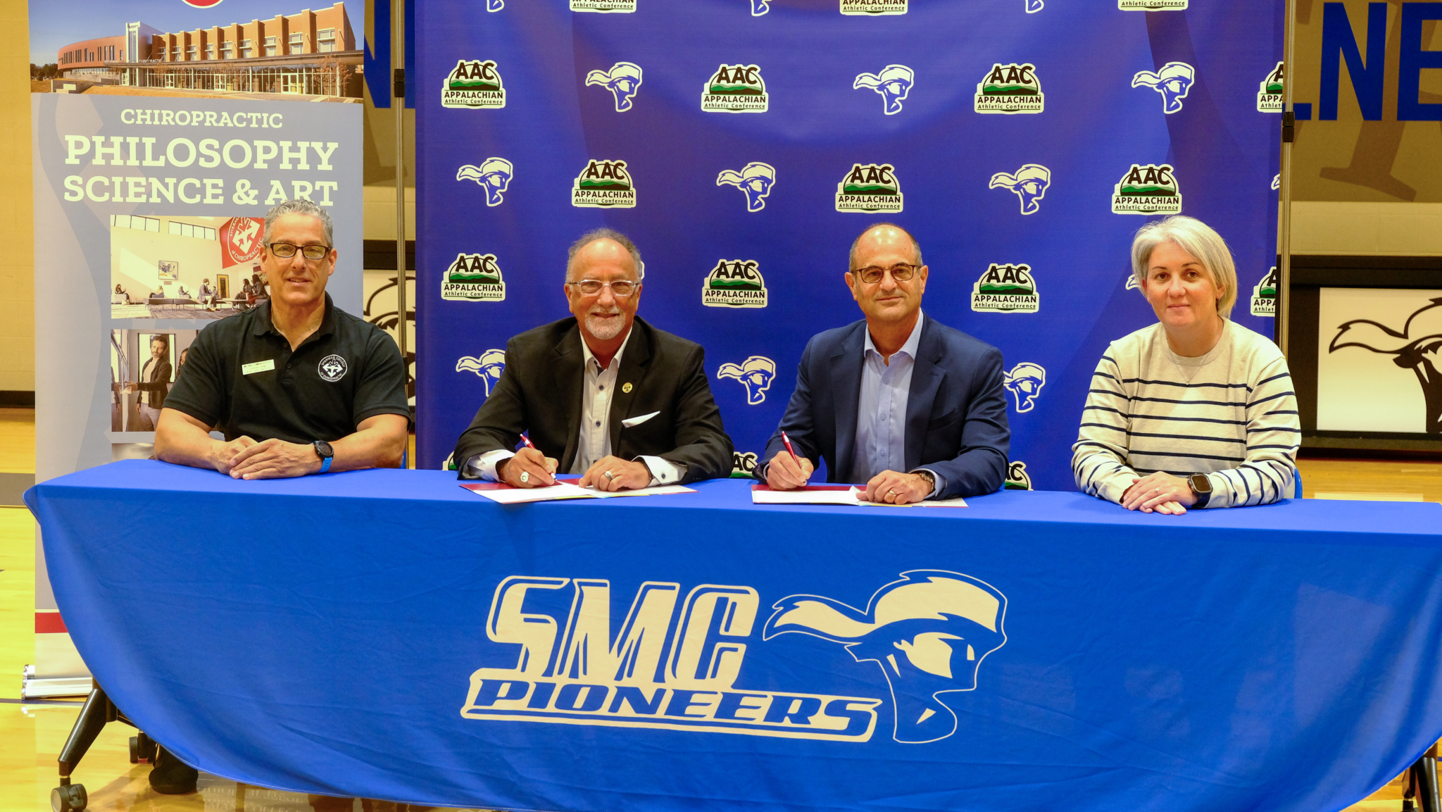 Four people stand together at a signing event celebrating the renewed partnership between Sherman College of Chiropractic and Spartanburg Methodist College. From left: Dr. Michael L. Tomasello, Dr. Jack Bourla, Scott Cochran, and Megan Aiello.