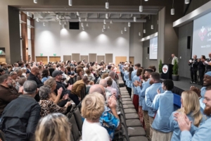 Audience of the Winter 2026 Pinning ceremony standing and applauding