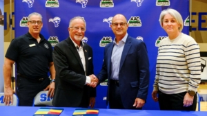 Four people stand together at a signing event celebrating the renewed partnership between Sherman College of Chiropractic and Spartanburg Methodist College. From left: Dr. Michael L. Tomasello, Dr. Jack Bourla, Scott Cochran, and Megan Aiello.