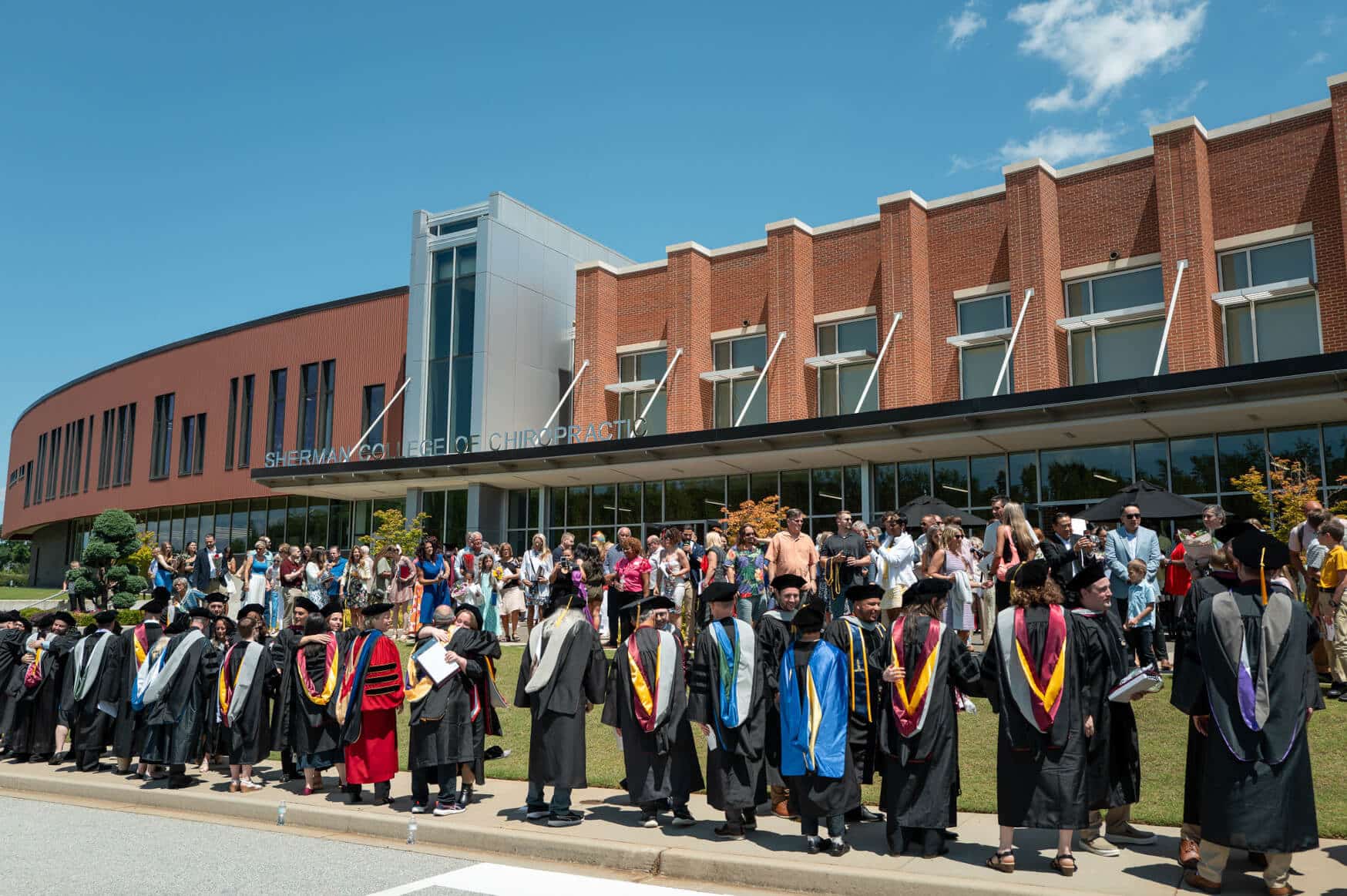 Sherman graduates greet and celebrate in the long-standing tradition – the faculty receiving line – following the June 13, 2026, graduation ceremony.