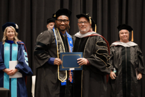 Accepting the Service Distinction Award is September 2026 graduate, Aquil Holden, with Sherman Provost and Chief Academic Officer, Dr. Joe Donofrio.