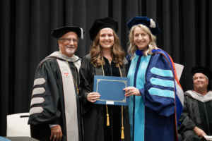 Elizabeth Travis (center) receives the Milton W. Garfunkel Award, Sherman’s highest graduation award, from (left) Sherman President Dr. Jack Bourla and (right) Executive Vice President Dr. Karen Canup.