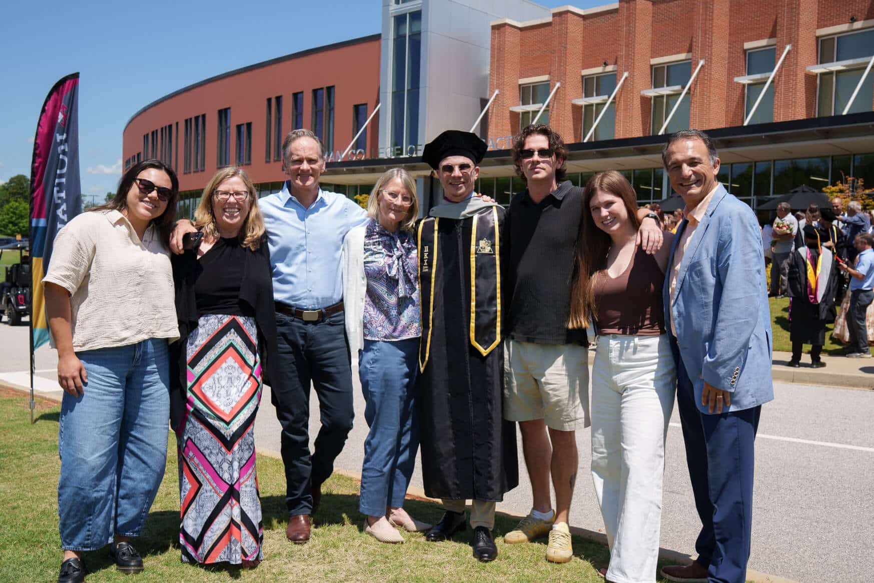 A family celebrating with a sherman graduation following the commencement event