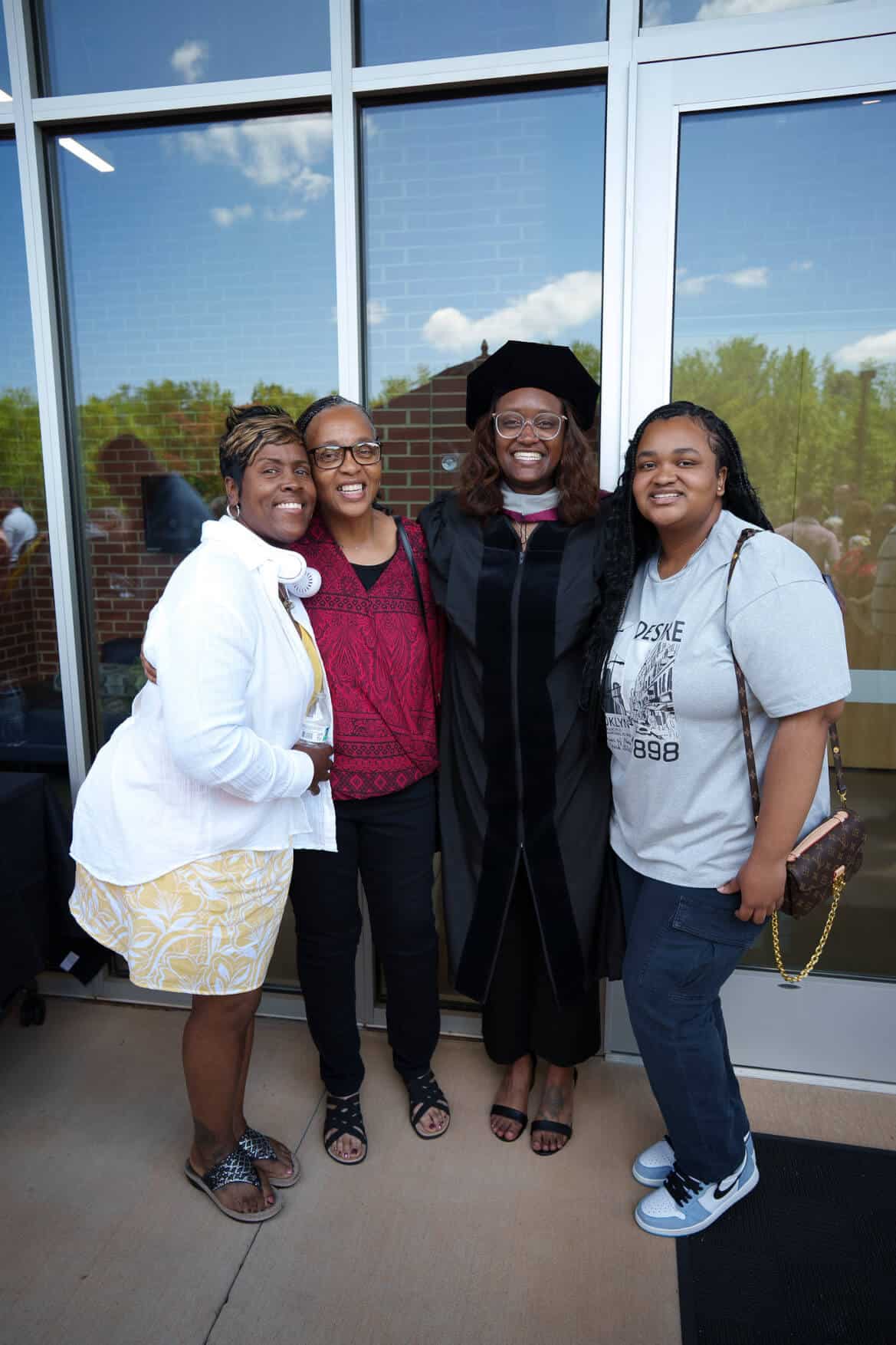 A family celebrating with a sherman graduation following the commencement event