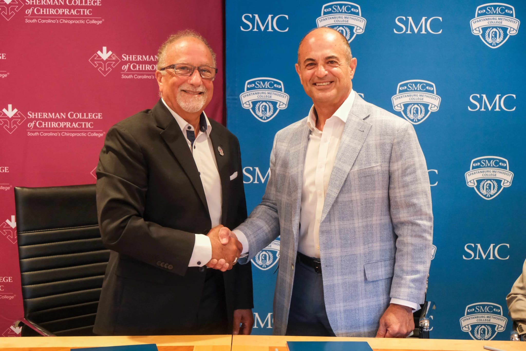 Sherman College of Chiropractic President Dr. Jack Bourla and Spartanburg Methodist College President Scott Cochran stand together at the signing of a new articulation agreement. The partnership creates a streamlined pathway and guarantees admission to Sherman College's Doctor of Chiropractic program for qualified SMC graduates who complete the required pre-chiropractic coursework and admission requirements.