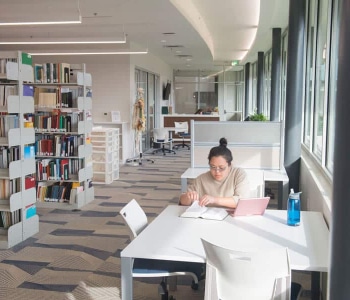 student studying in library